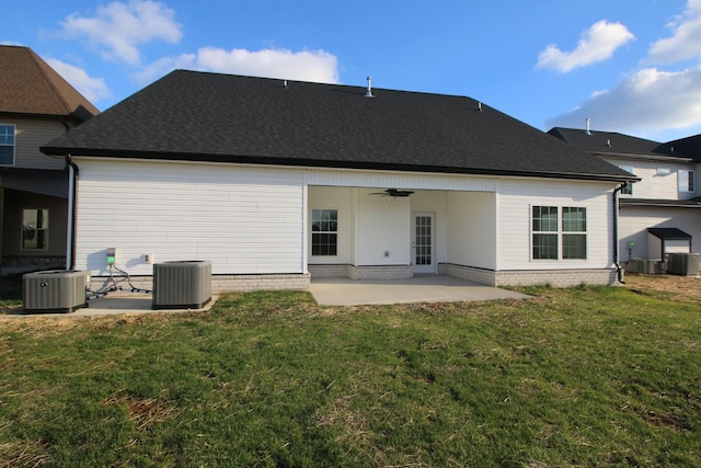 rear view of property featuring a patio area, a lawn, and central AC unit