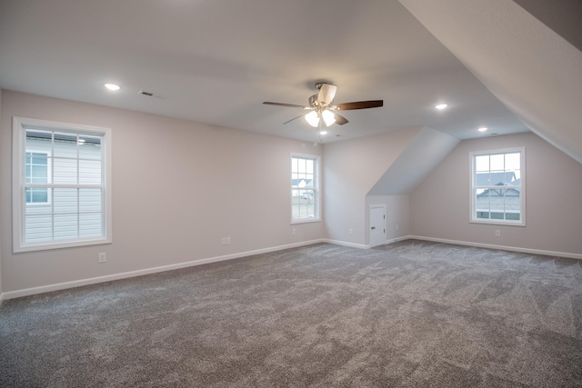 additional living space featuring carpet floors, baseboards, and a wealth of natural light