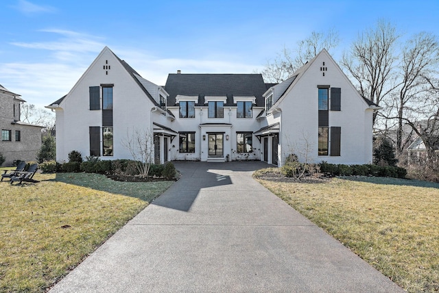 view of front of home with a front yard and concrete driveway