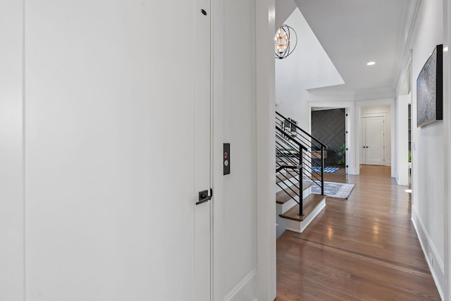 hallway with dark wood-style floors, baseboards, stairway, and recessed lighting