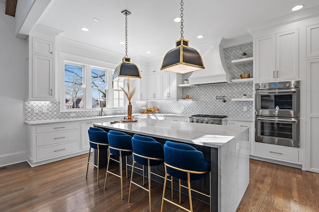 kitchen featuring open shelves, stainless steel double oven, a kitchen island, and white cabinets