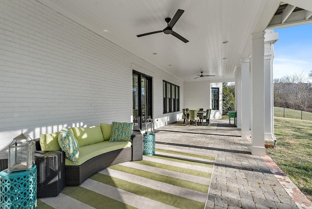 view of patio with ceiling fan and an outdoor living space