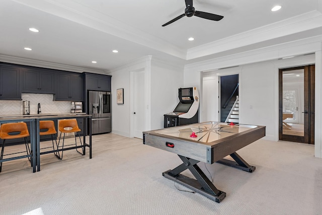 recreation room with a ceiling fan, recessed lighting, light carpet, and crown molding