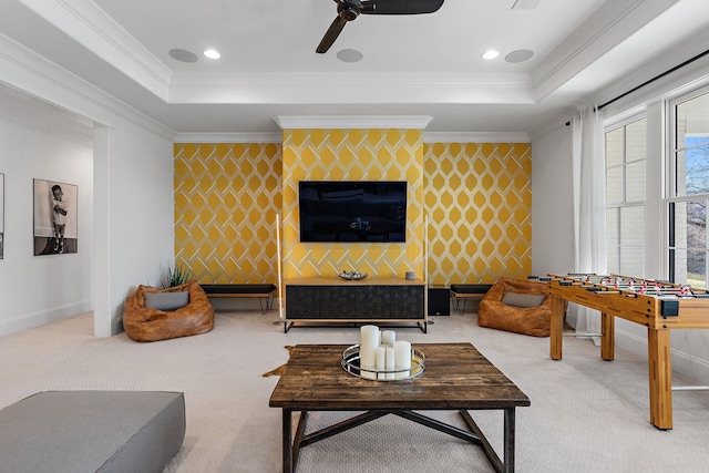 living area featuring a tray ceiling, light colored carpet, and wallpapered walls