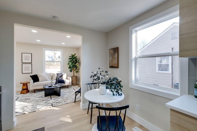 dining room with light wood-type flooring, baseboards, and recessed lighting