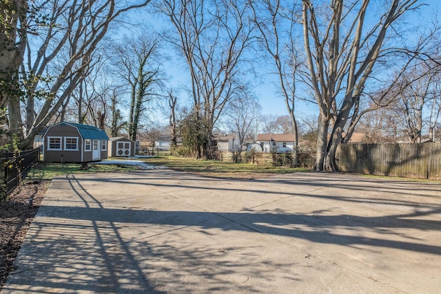 view of street with a residential view and concrete driveway