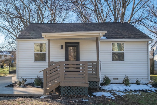 bungalow-style home with crawl space and roof with shingles