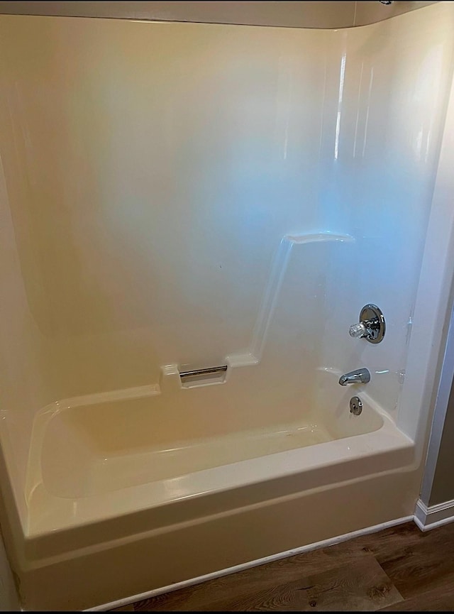 full bathroom featuring tub / shower combination and wood finished floors