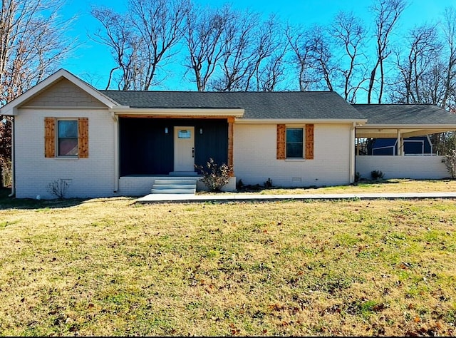 ranch-style house featuring brick siding, crawl space, roof with shingles, a carport, and a front yard