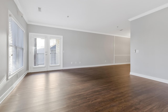 unfurnished room with baseboards, visible vents, ornamental molding, and dark wood-style flooring