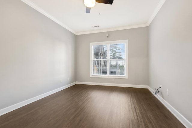 empty room featuring dark wood-style flooring, crown molding, and baseboards