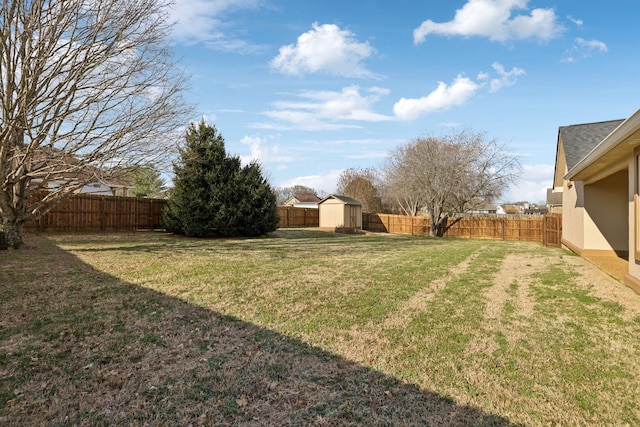 view of yard featuring a fenced backyard, an outdoor structure, and a shed