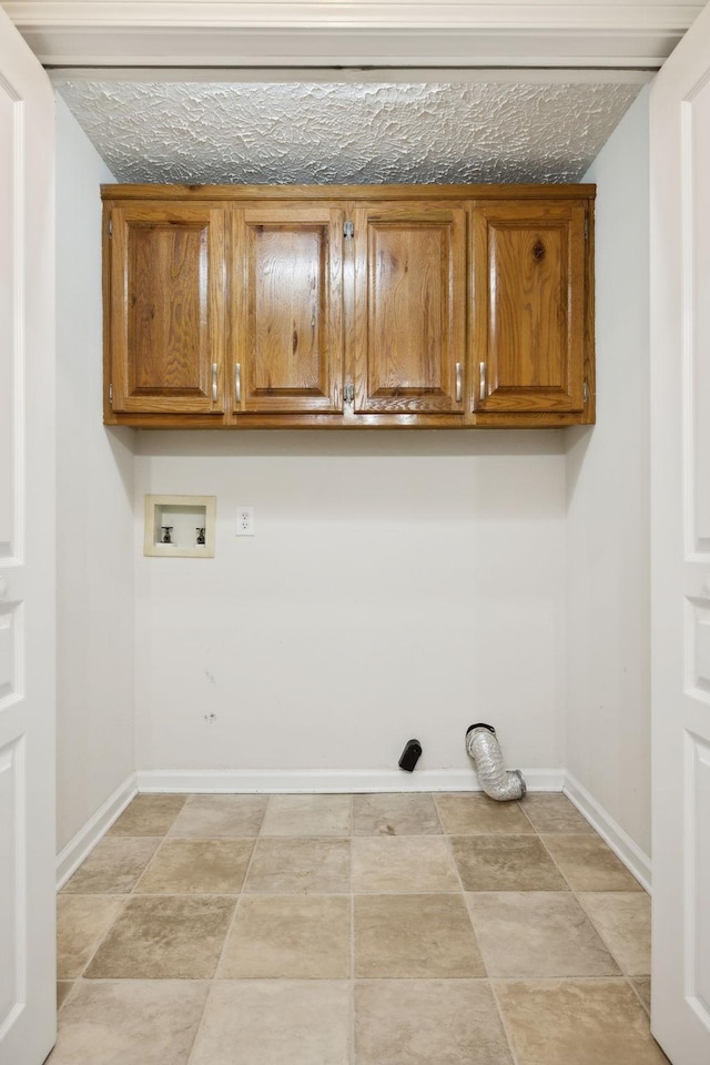 laundry area featuring hookup for a washing machine, cabinet space, and baseboards