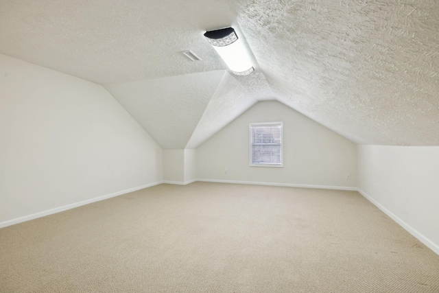 bonus room featuring vaulted ceiling, carpet floors, visible vents, and baseboards