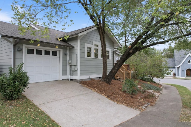 view of property exterior with an attached garage, crawl space, a shingled roof, and concrete driveway