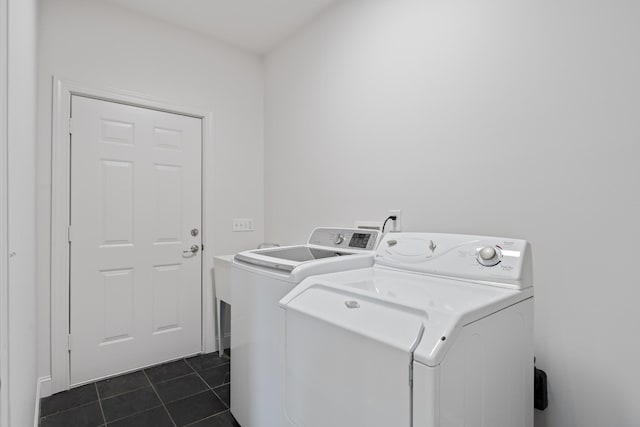 laundry area featuring laundry area, separate washer and dryer, and dark tile patterned floors