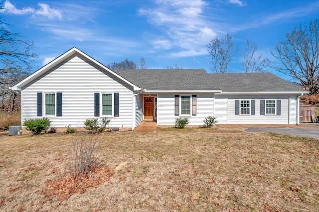 ranch-style house featuring crawl space, roof with shingles, and a front yard