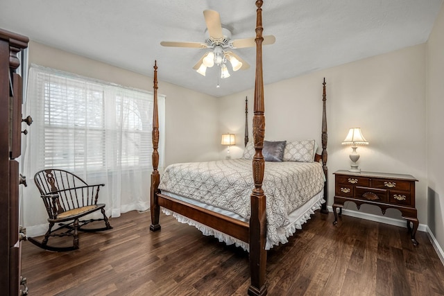 bedroom featuring dark wood-style floors, baseboards, and a ceiling fan