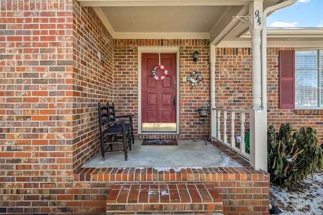 doorway to property with brick siding