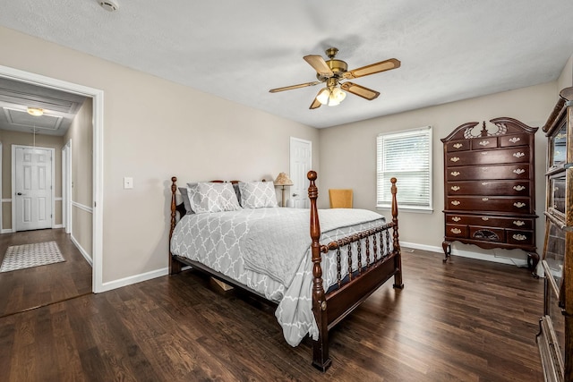 bedroom featuring a ceiling fan, dark wood-style flooring, attic access, and baseboards