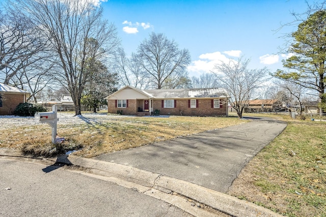 view of front of property with a front yard and brick siding