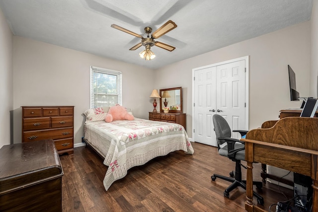 bedroom featuring a closet, dark wood finished floors, baseboards, and ceiling fan