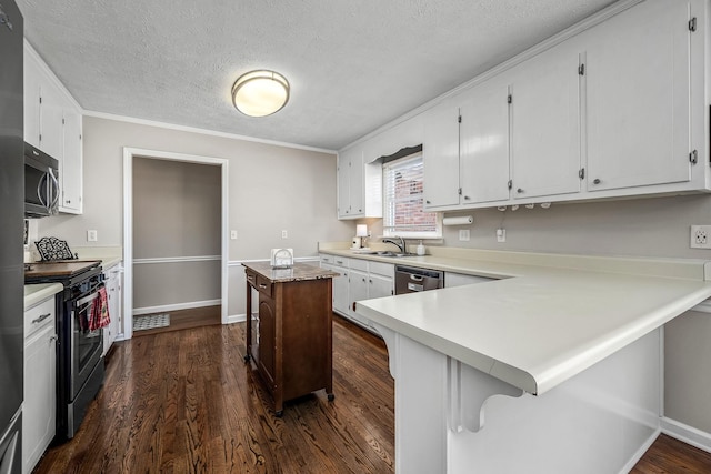 kitchen featuring a peninsula, stainless steel appliances, dark wood-style flooring, white cabinets, and light countertops