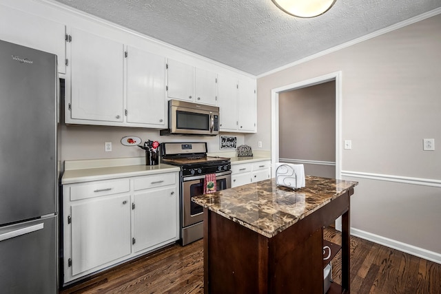 kitchen featuring stainless steel appliances, a center island, white cabinets, and dark wood-type flooring