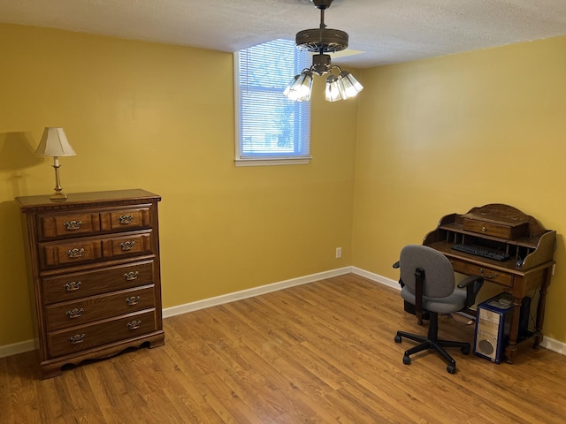 office area with baseboards and light wood finished floors