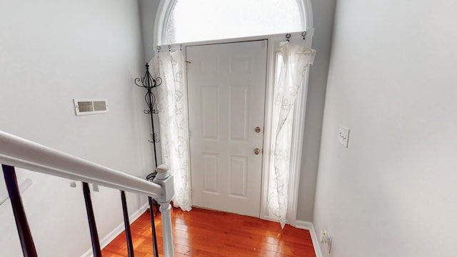 entrance foyer with wood finished floors and visible vents