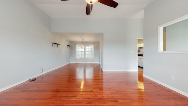 unfurnished living room with baseboards, ceiling fan, and light wood finished floors