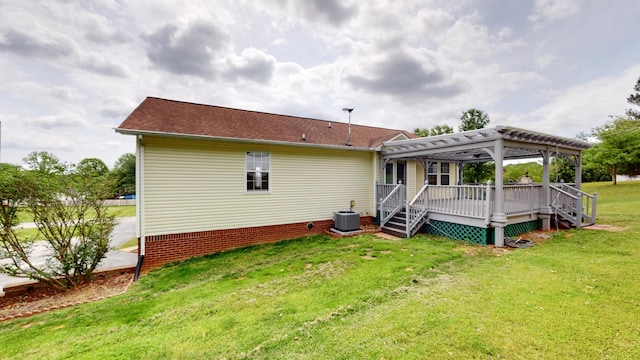 back of property featuring cooling unit, a lawn, a pergola, and a wooden deck