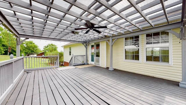 deck featuring a ceiling fan and a yard
