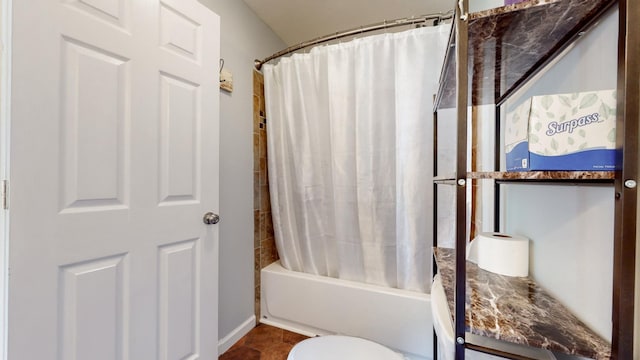 full bathroom featuring tile patterned flooring, toilet, and shower / tub combo with curtain