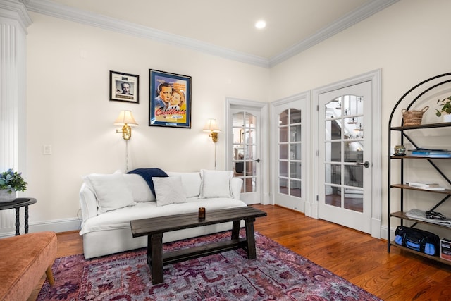 sitting room with recessed lighting, crown molding, baseboards, and wood finished floors