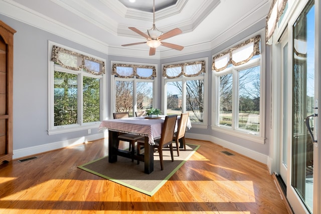 sunroom with visible vents and a tray ceiling