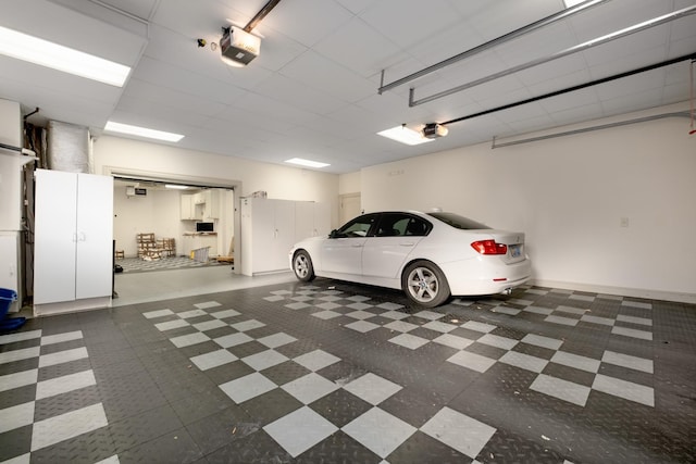 garage with a garage door opener and baseboards