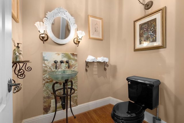 bathroom featuring baseboards and wood finished floors