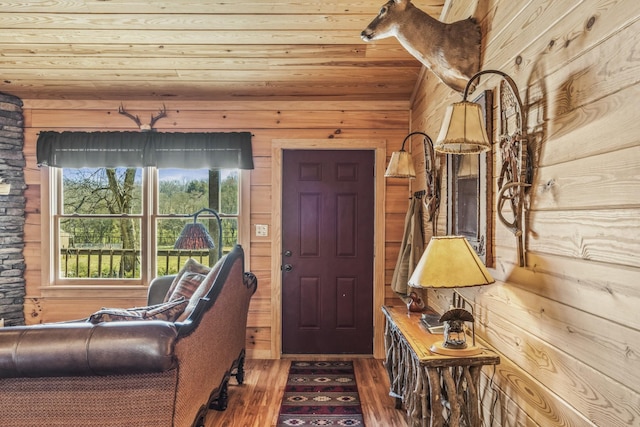 foyer entrance featuring wood ceiling, wood walls, and wood finished floors