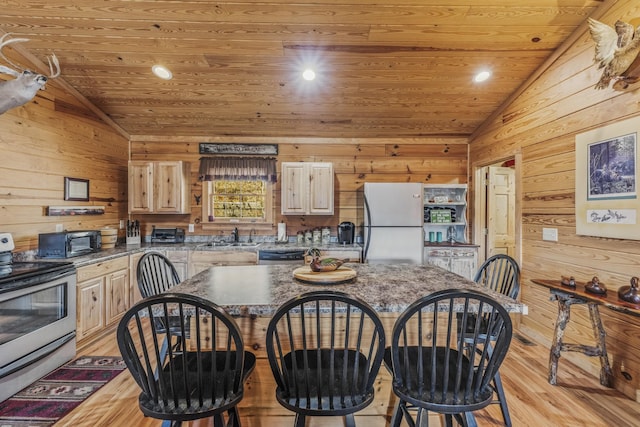 kitchen with lofted ceiling, appliances with stainless steel finishes, wooden ceiling, and light brown cabinets