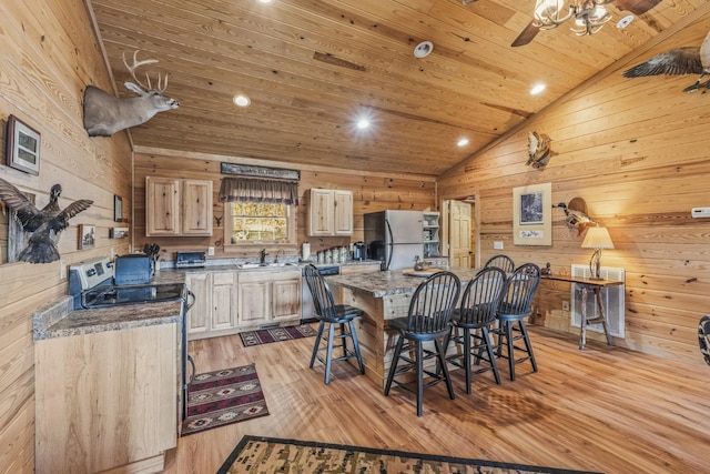 kitchen featuring light stone counters, wooden ceiling, light brown cabinets, stainless steel appliances, and vaulted ceiling