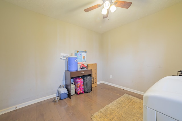 bedroom featuring ceiling fan, baseboards, and wood finished floors