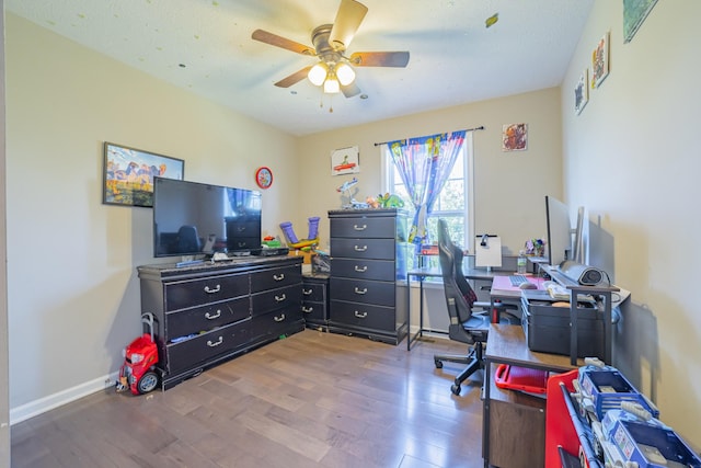 office featuring ceiling fan, a textured ceiling, baseboards, and wood finished floors