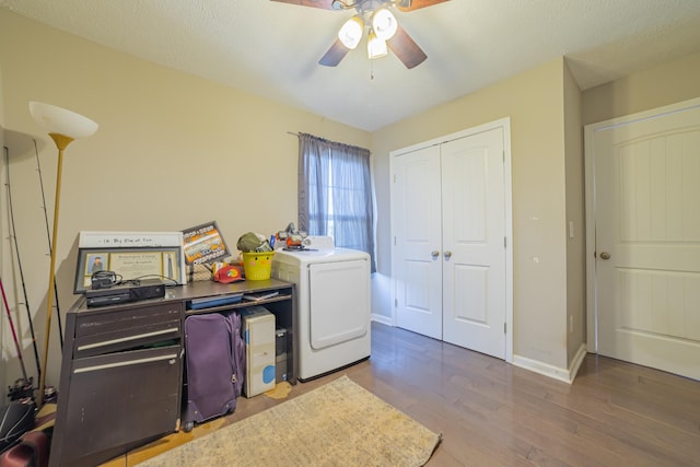 interior space featuring washer / dryer, baseboards, ceiling fan, wood finished floors, and a textured ceiling