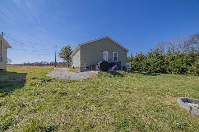 rear view of house featuring crawl space and a lawn