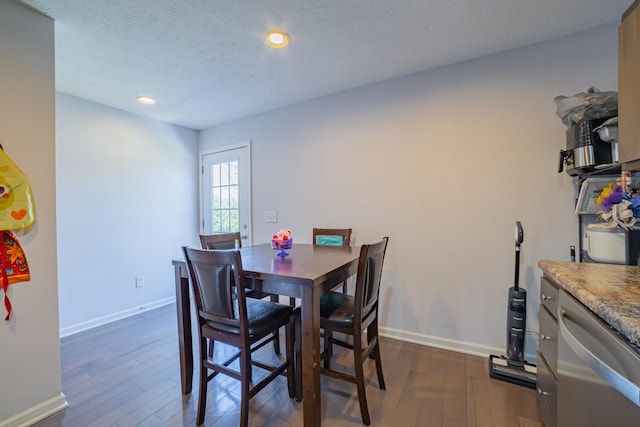 dining space featuring dark wood-style floors, recessed lighting, a textured ceiling, and baseboards