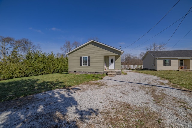 bungalow-style home featuring crawl space, driveway, and a front lawn