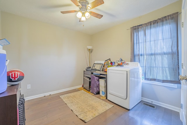 laundry room featuring visible vents, light wood-style floors, washer / dryer, laundry area, and baseboards