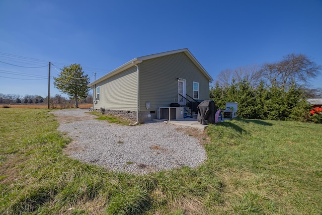 view of home's exterior featuring crawl space and a yard