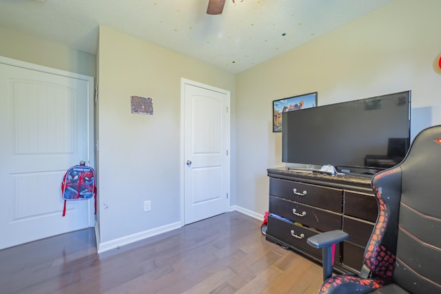 bedroom featuring ceiling fan, wood finished floors, and baseboards